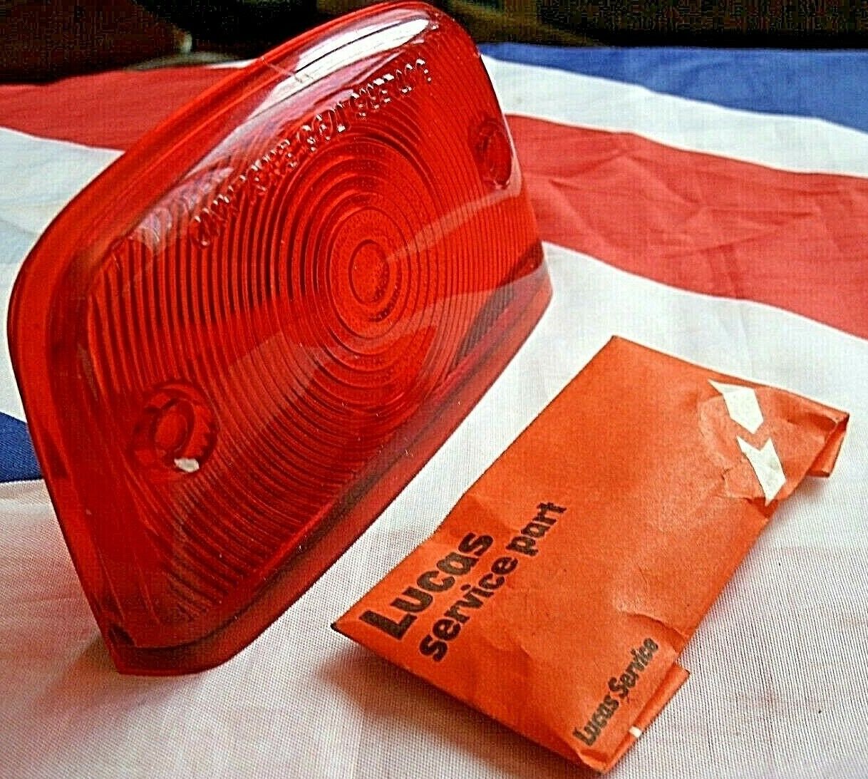 One New Old Stock Red Bedford TK Rear Light Lens Lucas Butlers With Fitting Kit.