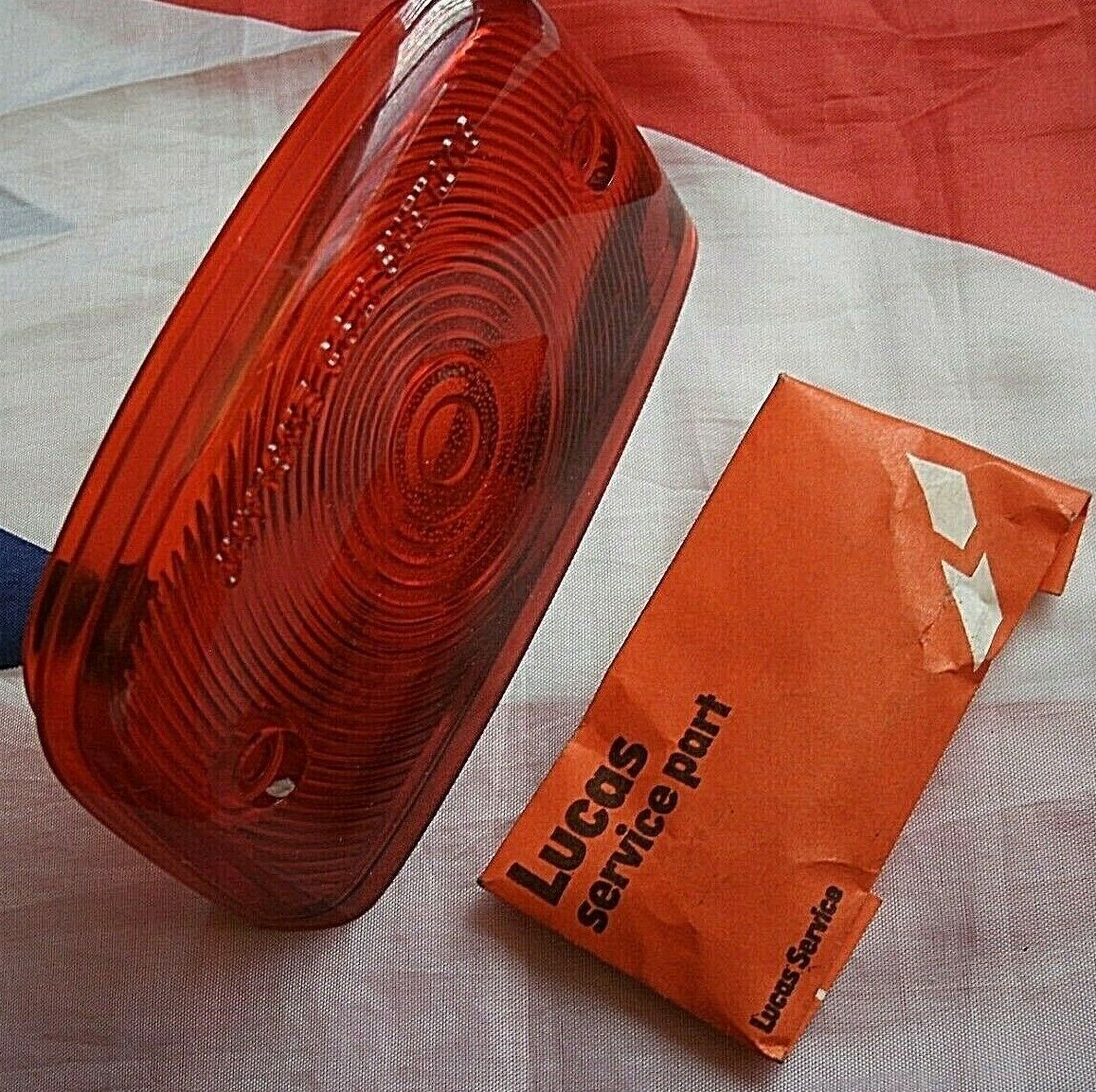 One New Old Stock Red Bedford TK Rear Light Lens Lucas Butlers With Fitting Kit.